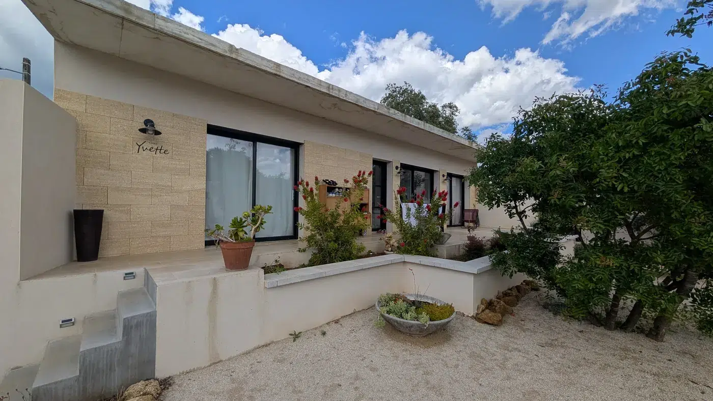 Villa contemporaine à toit plat avec débord béton et parement pierre à Vers-Pont-du-Gard